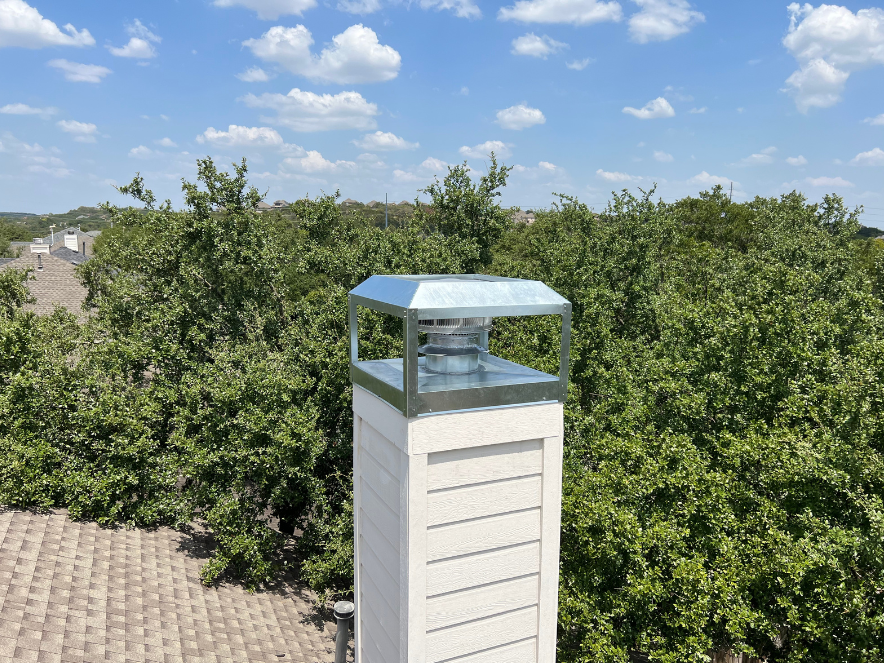 Tall galvanized cap against a cloudy sky
